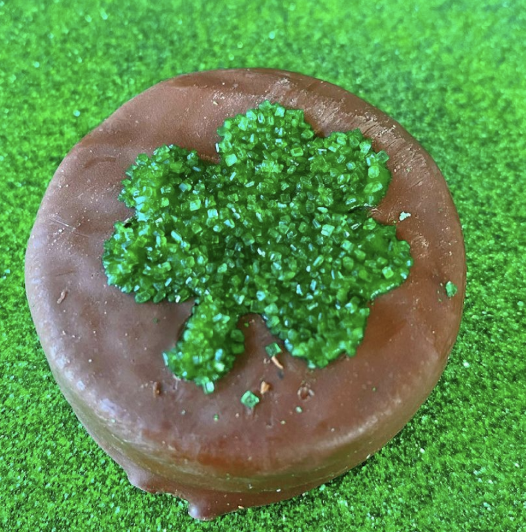 Chocolate covered oreo with a shamrock on it