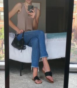 Maddie wearing the sandals taking a mirror pictures