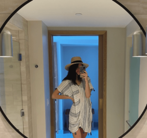 Maddie taking a mirror photo in the surf gypsy cover up