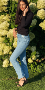 Image of Maddie Wearing Blue Jeans and Black Shirt and Sandals
