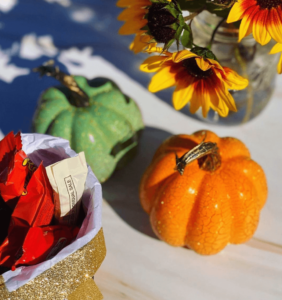 Image of decorative pumpkins, flowers and a bowl with candy
