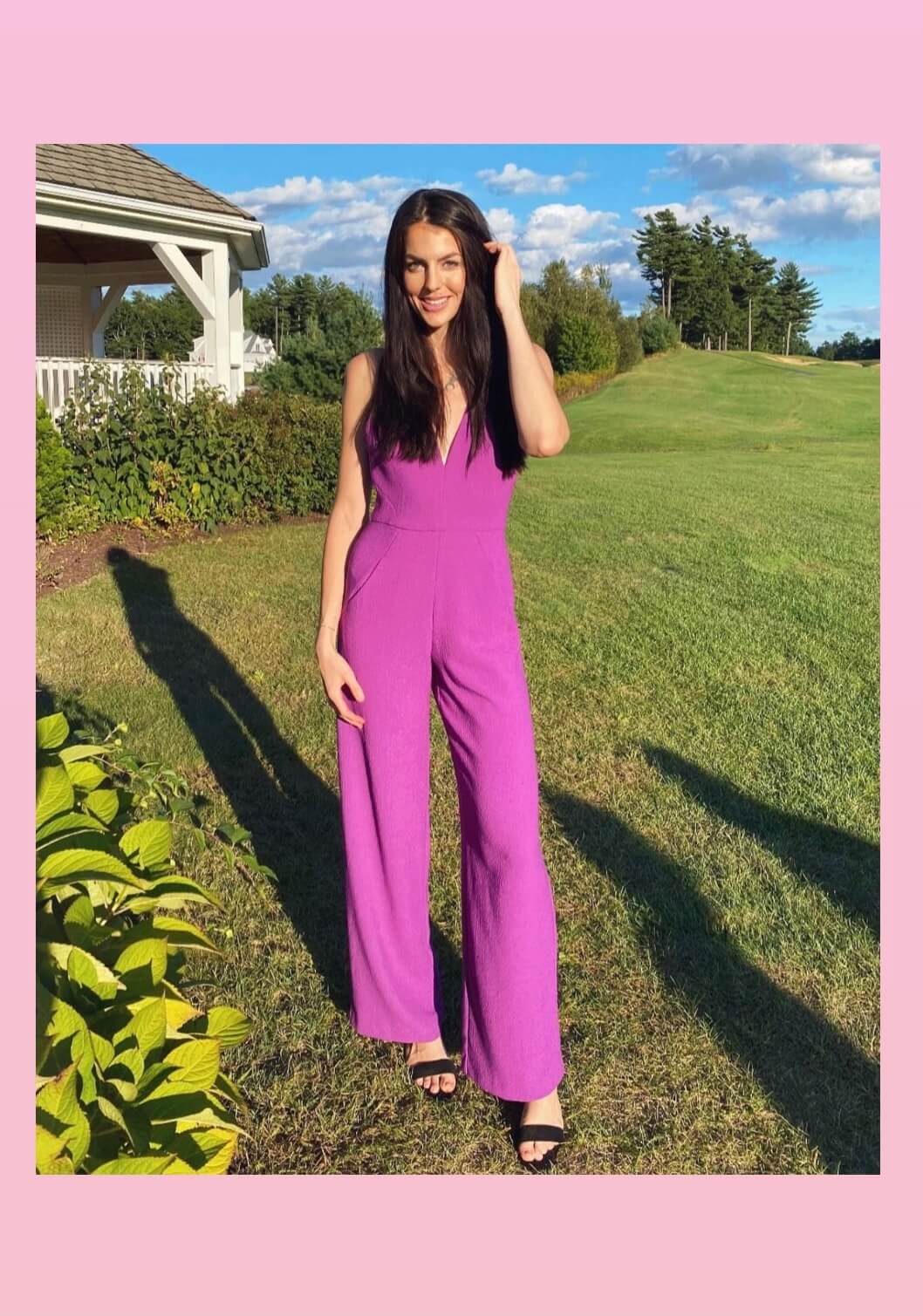 Image of Maddie standing outside in a purple jumpsuit