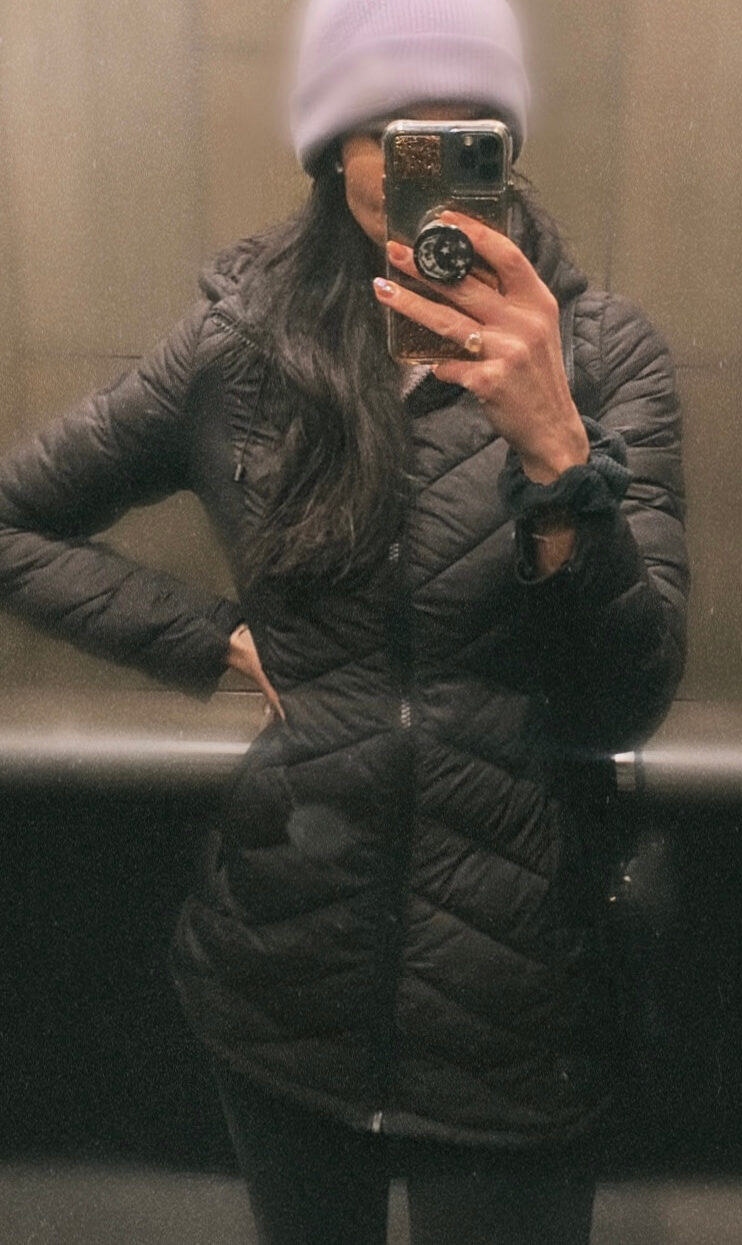 Image of Maddie wearing a winter jacket in an elevator