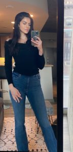 Image of Maddie in off the shoulder sweater and jeans 