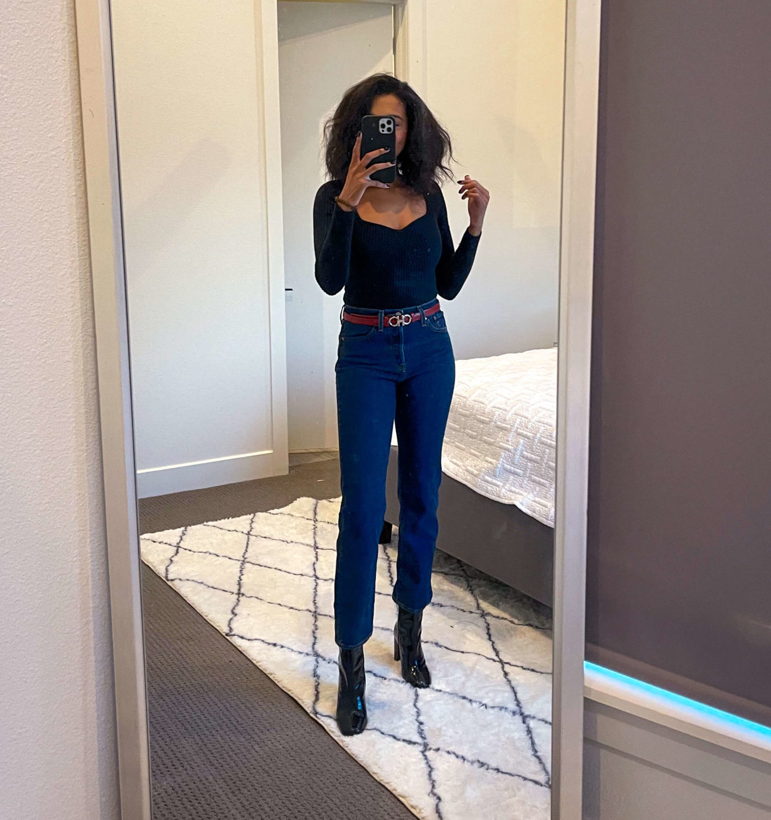 Image of Sara wearing a sweater with jeans