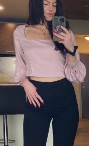 Image of Maddie Wearing a pink date night top 